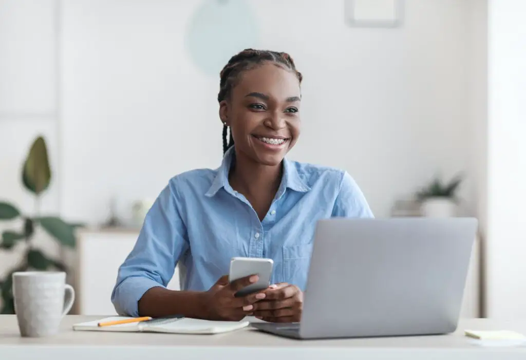 Self-Employment. Joyful Black Millennial Woman Sitting At Workplace In Home Office