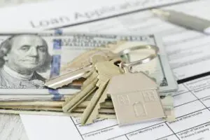 Housing Market concept - house keys on money currency home loan application, real estate mortgage