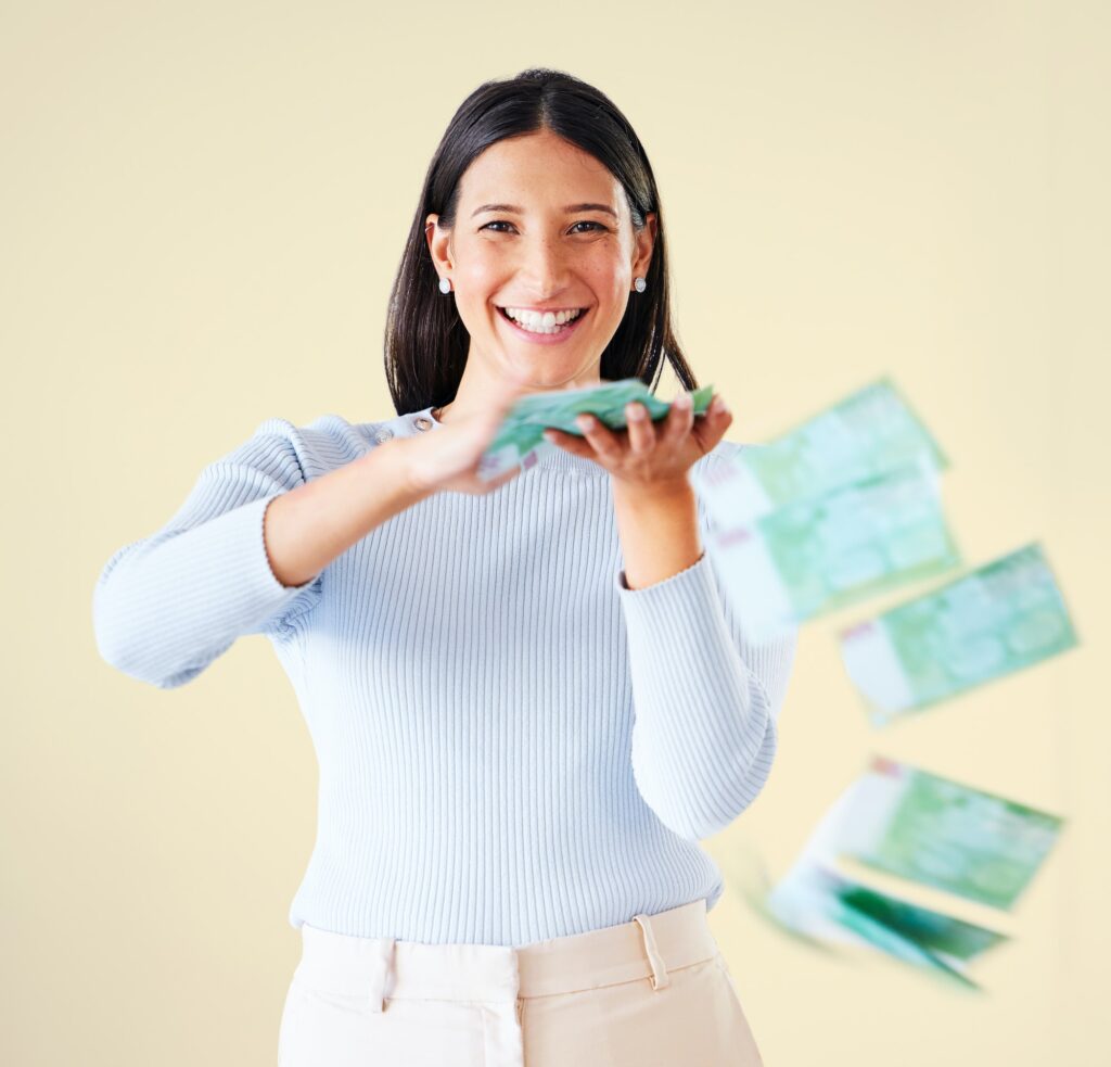 Wealthy, rich and happy woman throwing money smiling about her financial success and freedom. Portr